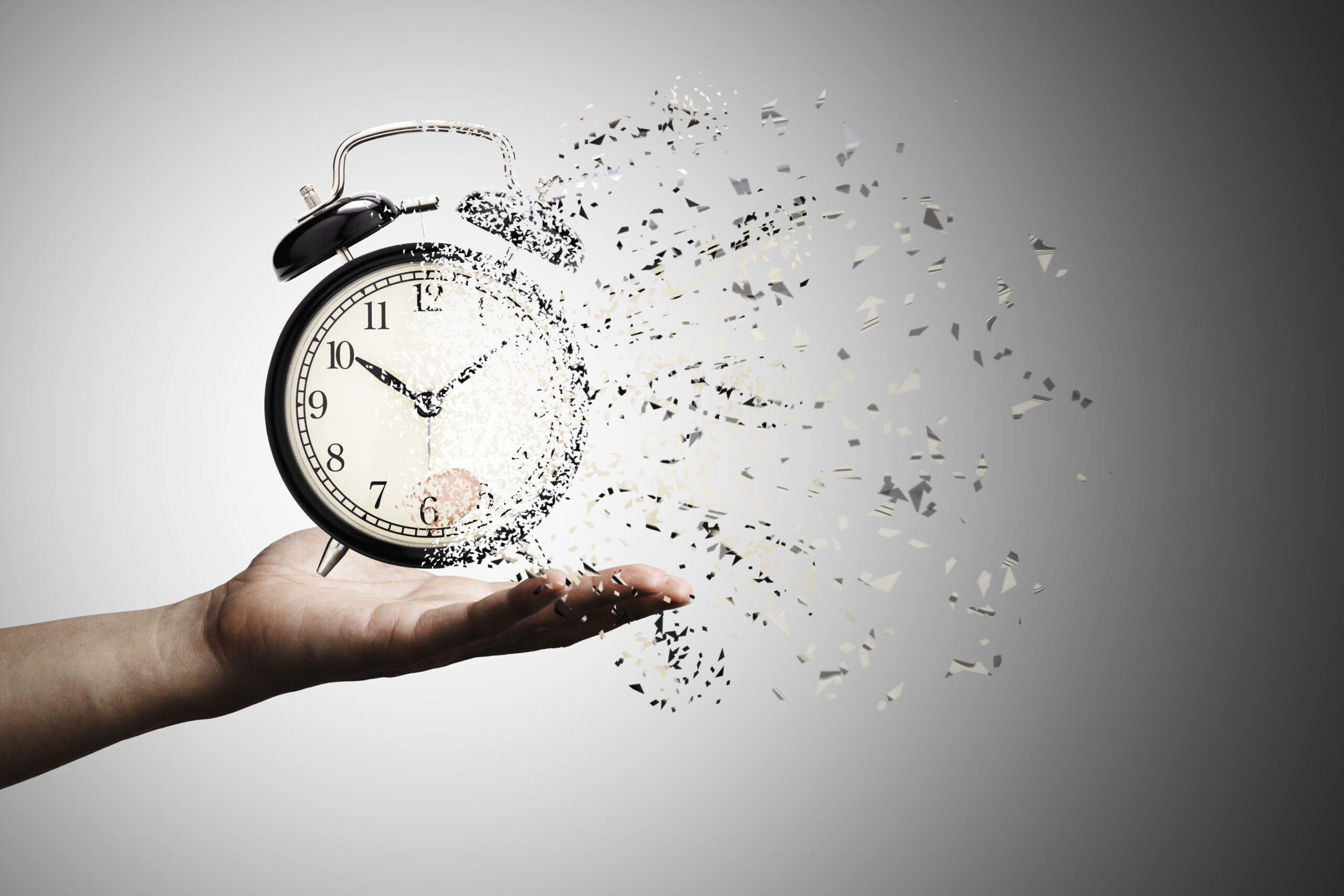 Retro black alarm clock dissolving into a little particles for time can not return and never wait anyone , Time management concept.